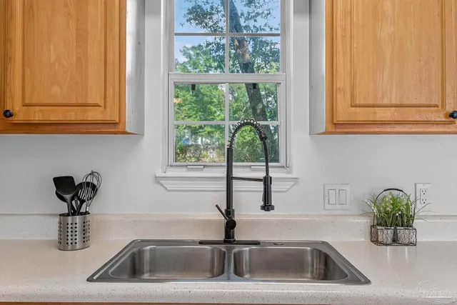 a kitchen with a sink and a window