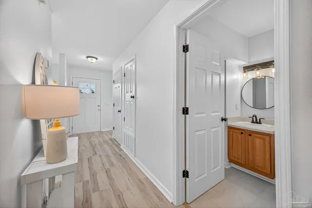 a spacious bathroom with a toilet a sink a mirror and vanity