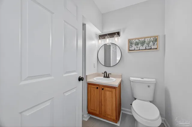 a bathroom with a toilet a sink and mirror