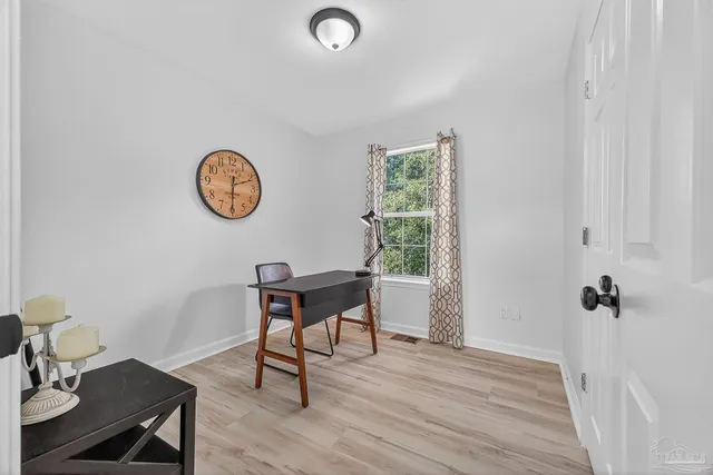 a view of a work space with furniture and wooden floor