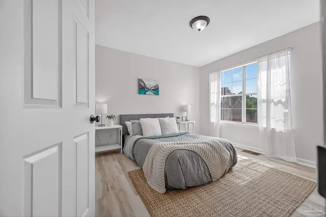 a bedroom with a bed and a window