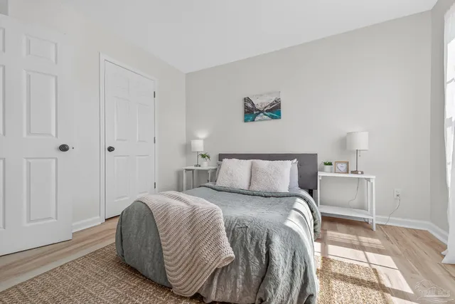 a bedroom with a bed and a painting on the wall