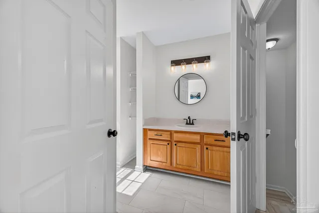 a spacious bathroom with a double vanity sink and a mirror