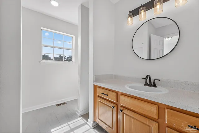 a bathroom with a sink a vanity and a mirror