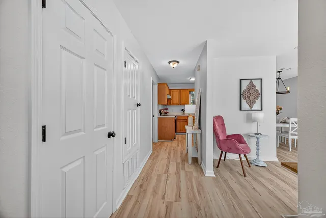 a hallway with wooden floor furniture and windows