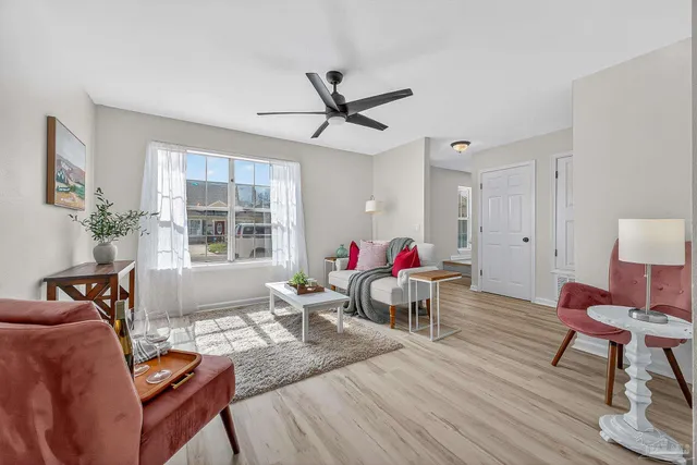 a living room with furniture and a wooden floor