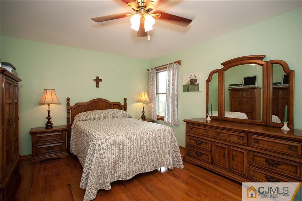 24 Gurley Road Edison, NJ 08817 - Photo 14 of 20 a bedroom with a bed and a dresser with mirror
