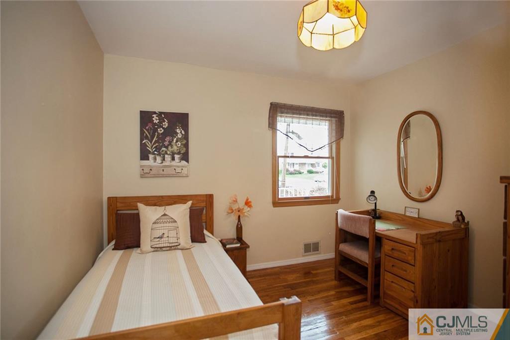 24 Gurley Road Edison, NJ 08817 - Photo 17 of 20 a bedroom with a bed and a chandelier