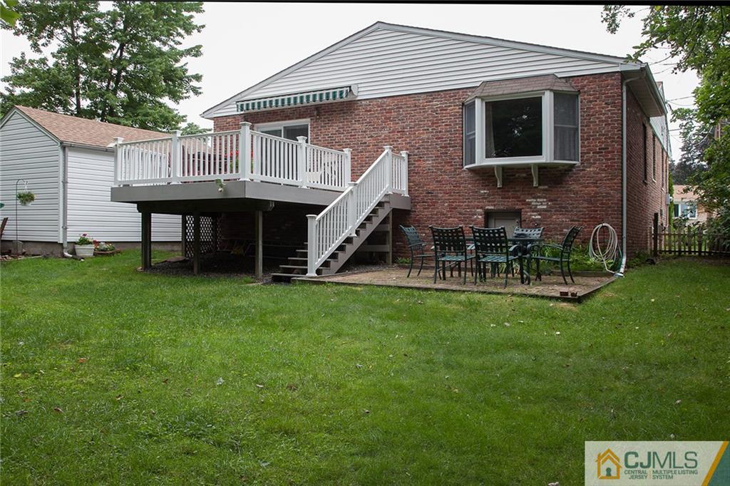 24 Gurley Road Edison, NJ 08817 - Photo 5 of 20 a view of a house with a backyard and a table