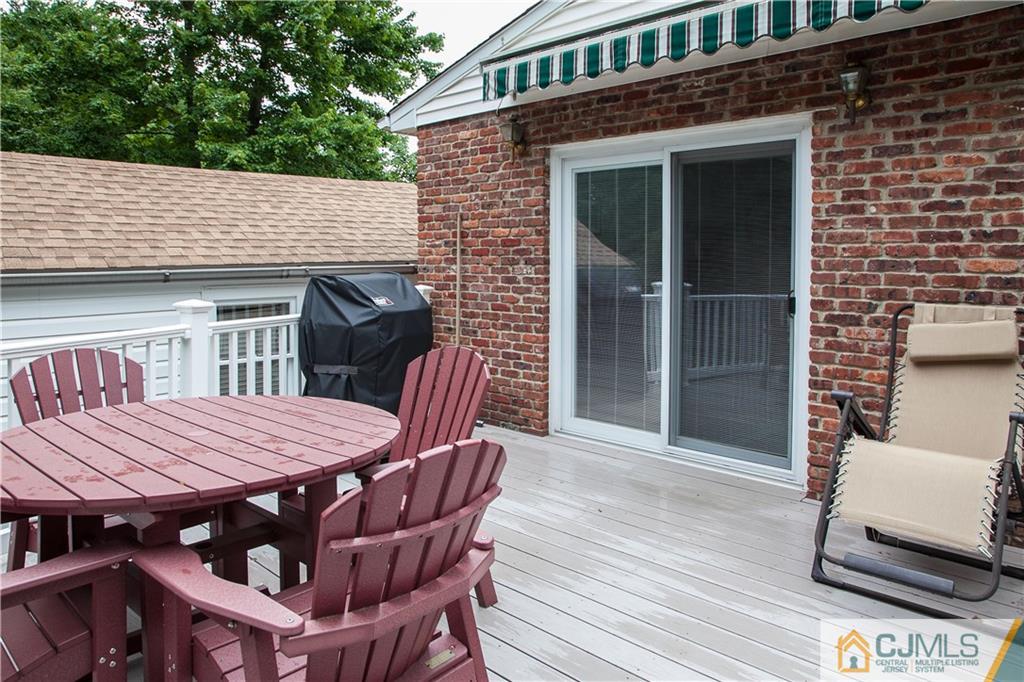 24 Gurley Road Edison, NJ 08817 - Photo 7 of 20 a view of a patio with table and chairs with wooden floor and fence