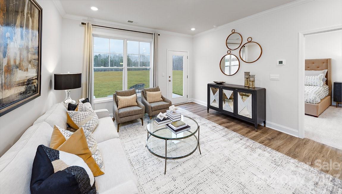7903 Iron Road Sherrills Ford, NC 28673 - Photo 12 of 41 a living room with furniture wooden floor and a large window