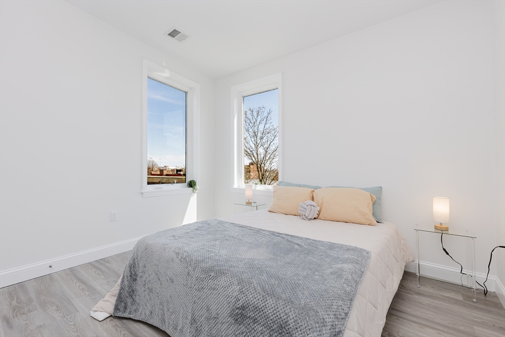 92-94 George Street, Unit 203 Boston, MA 02119 - Photo 19 of 35 a bedroom with a bed and a night lamp