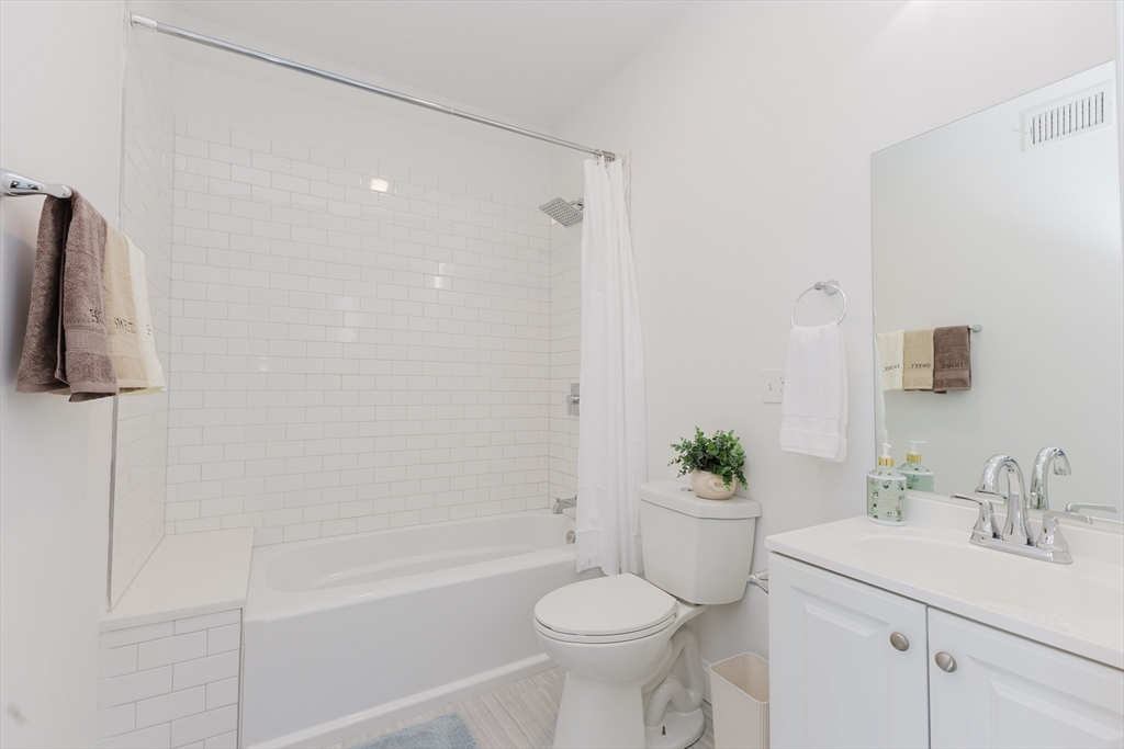 92-94 George Street, Unit 203 Boston, MA 02119 - Photo 21 of 35 a bathroom with a sink a toilet and shower