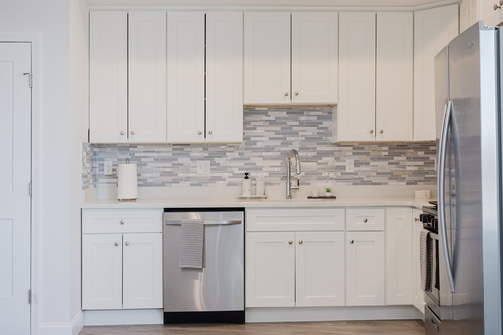 92-94 George Street, Unit 203 Boston, MA 02119 - Photo 28 of 35 a kitchen with white cabinets