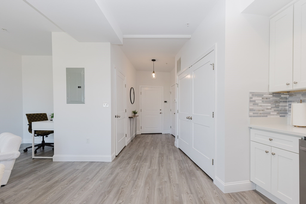 92-94 George Street, Unit 203 Boston, MA 02119 - Photo 3 of 35 a view of a hallway with wooden floor and a bathroom