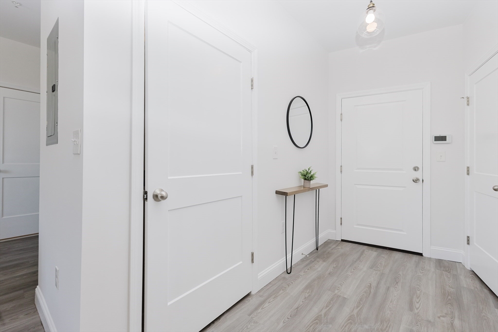 92-94 George Street, Unit 203 Boston, MA 02119 - Photo 7 of 35 a view of a room with wooden floor and white wall