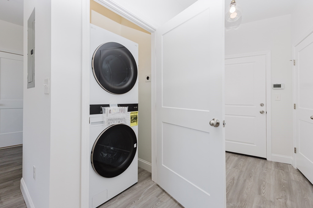 92-94 George Street, Unit 203 Boston, MA 02119 - Photo 8 of 35 a view of a hallway with washer and dryer