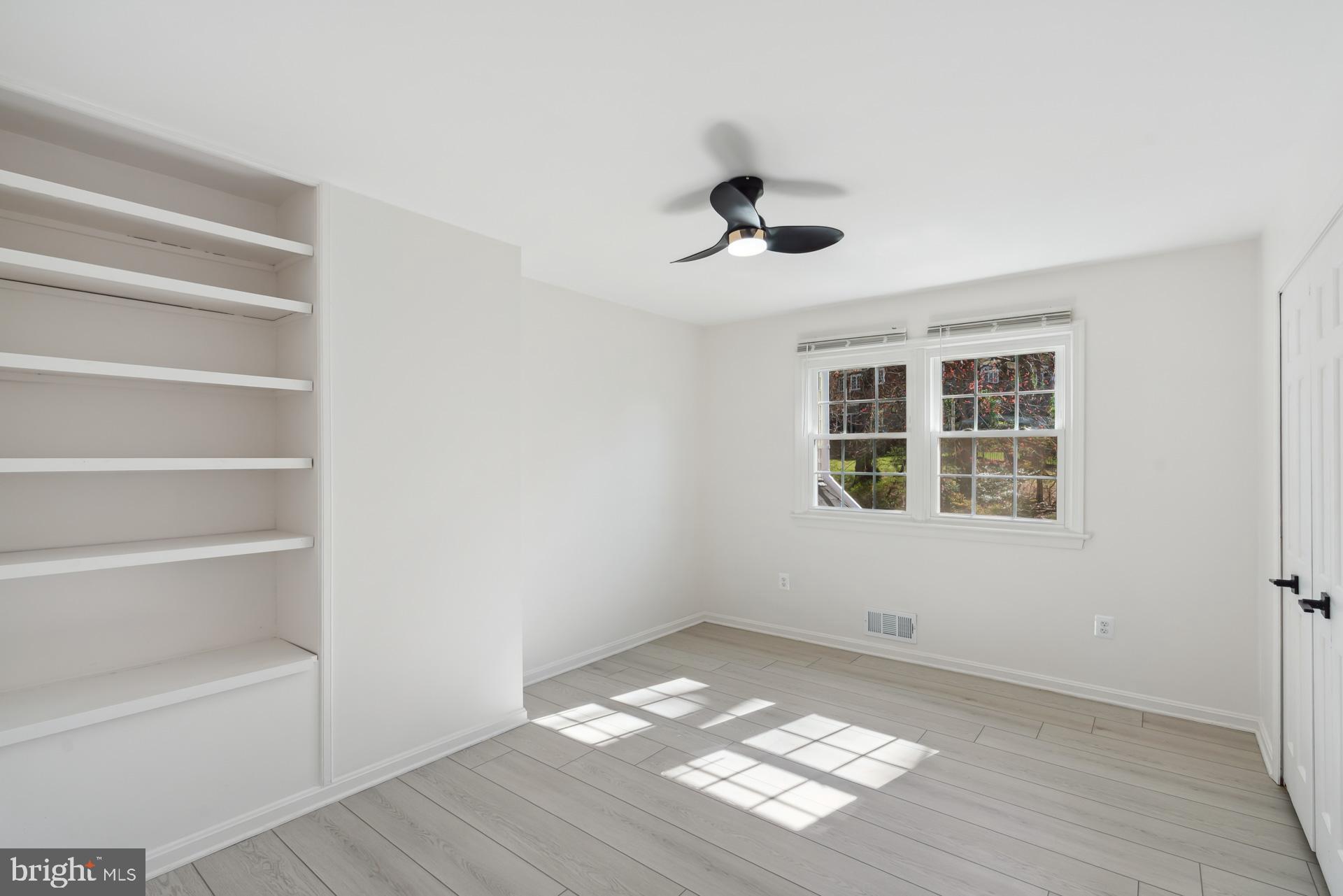 8417 Kingsgate Road Potomac, MD 20854 - Photo 33 of 61 a view of an empty room with a window and wooden floor