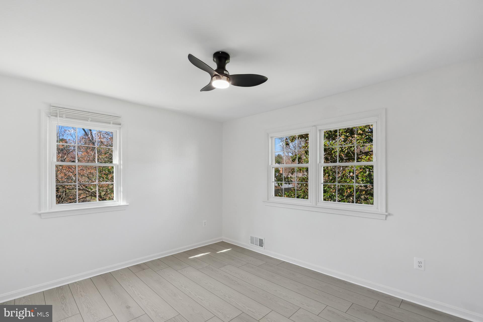 8417 Kingsgate Road Potomac, MD 20854 - Photo 35 of 61 a view of an empty room with a window and wooden floor