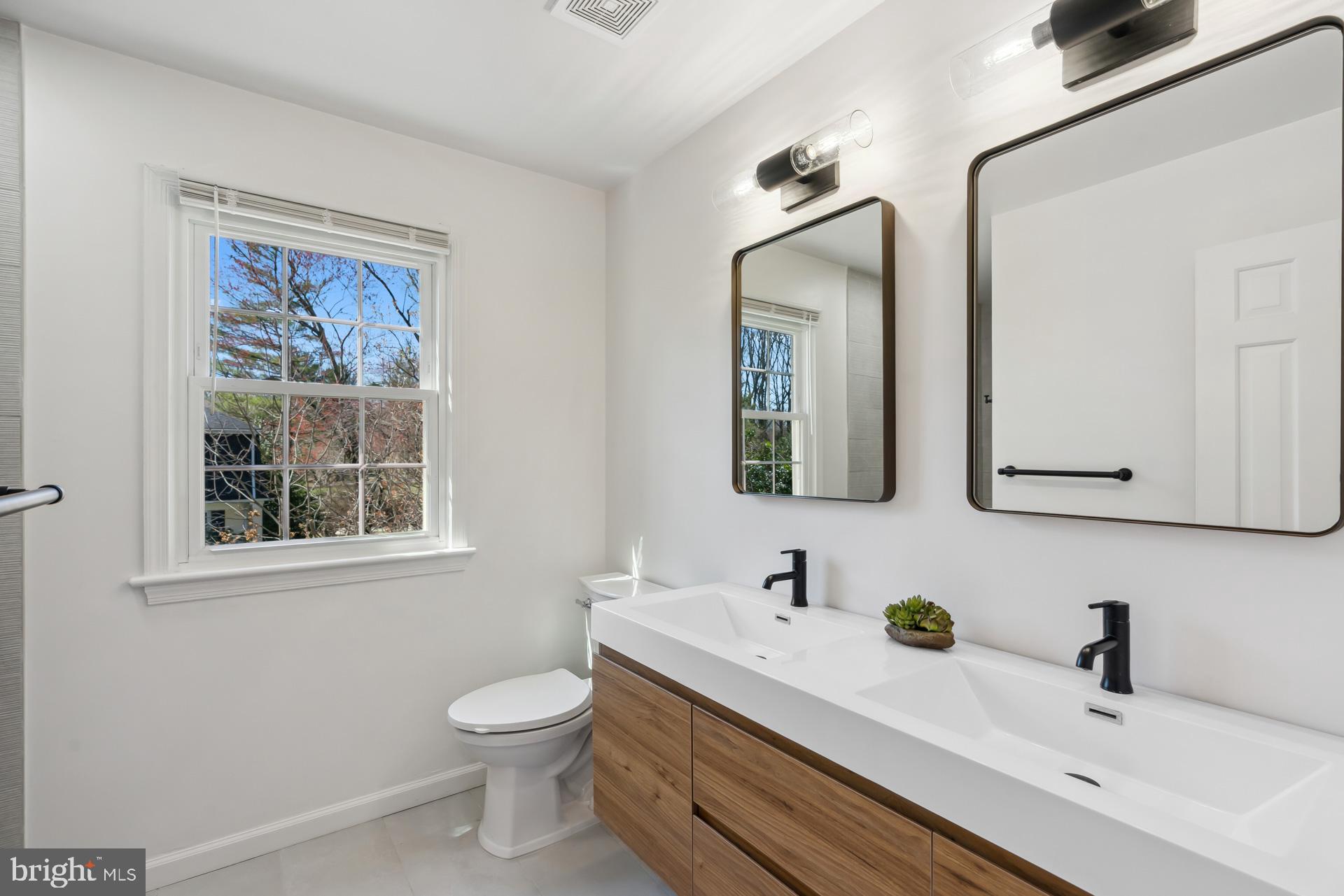 8417 Kingsgate Road Potomac, MD 20854 - Photo 36 of 61 a bathroom with a toilet sink and mirror