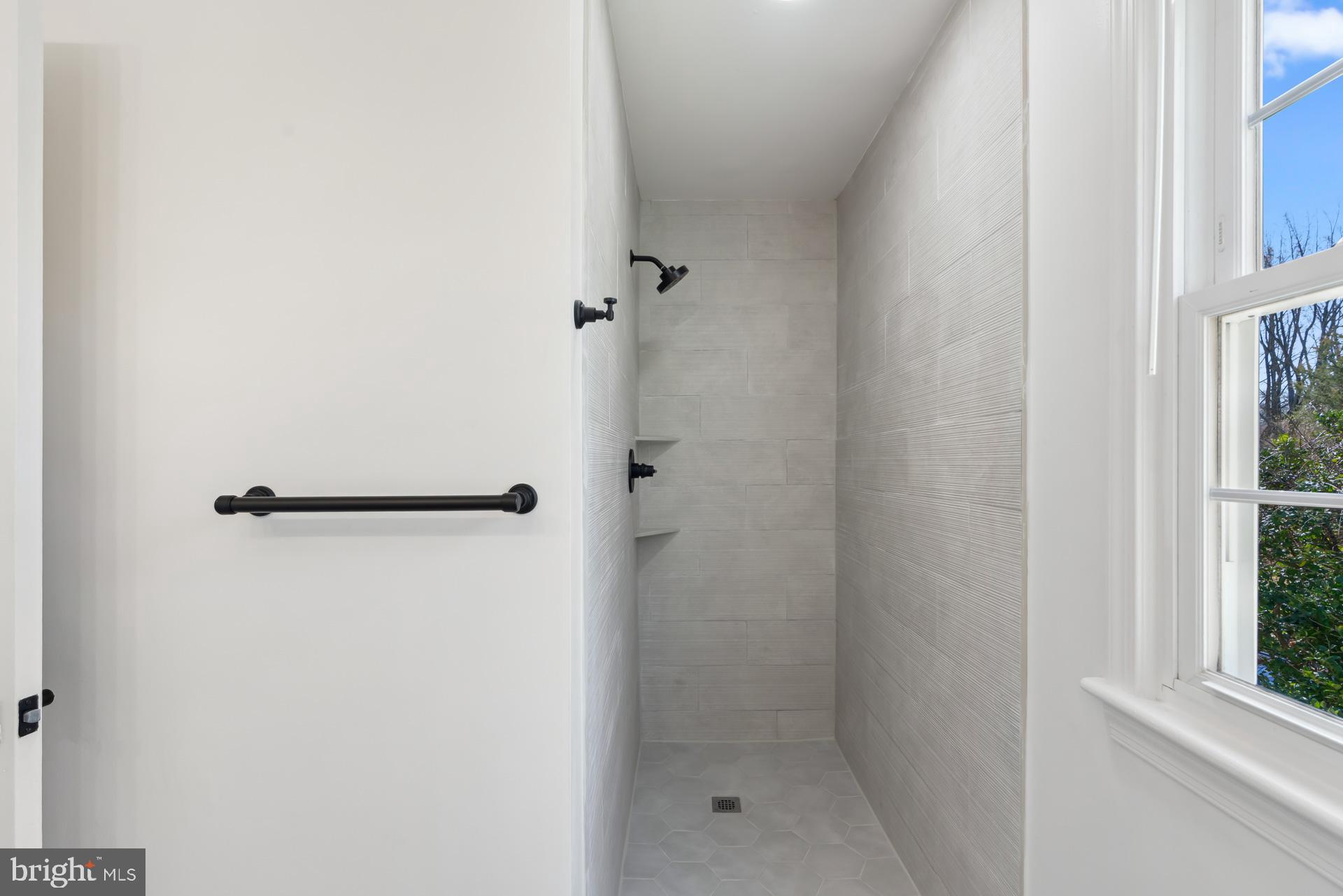 8417 Kingsgate Road Potomac, MD 20854 - Photo 37 of 61 a bathroom with a glass shower door