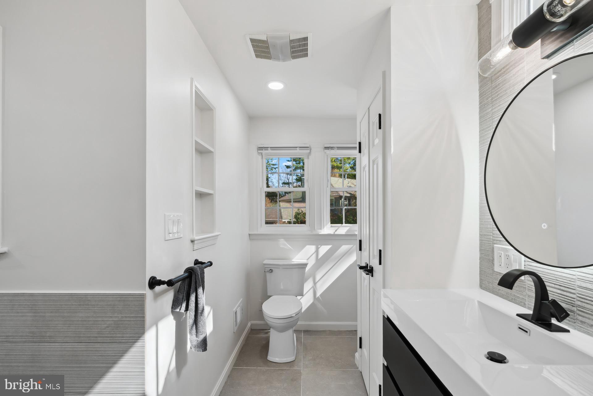 8417 Kingsgate Road Potomac, MD 20854 - Photo 45 of 61 a bathroom with a sink and a mirror