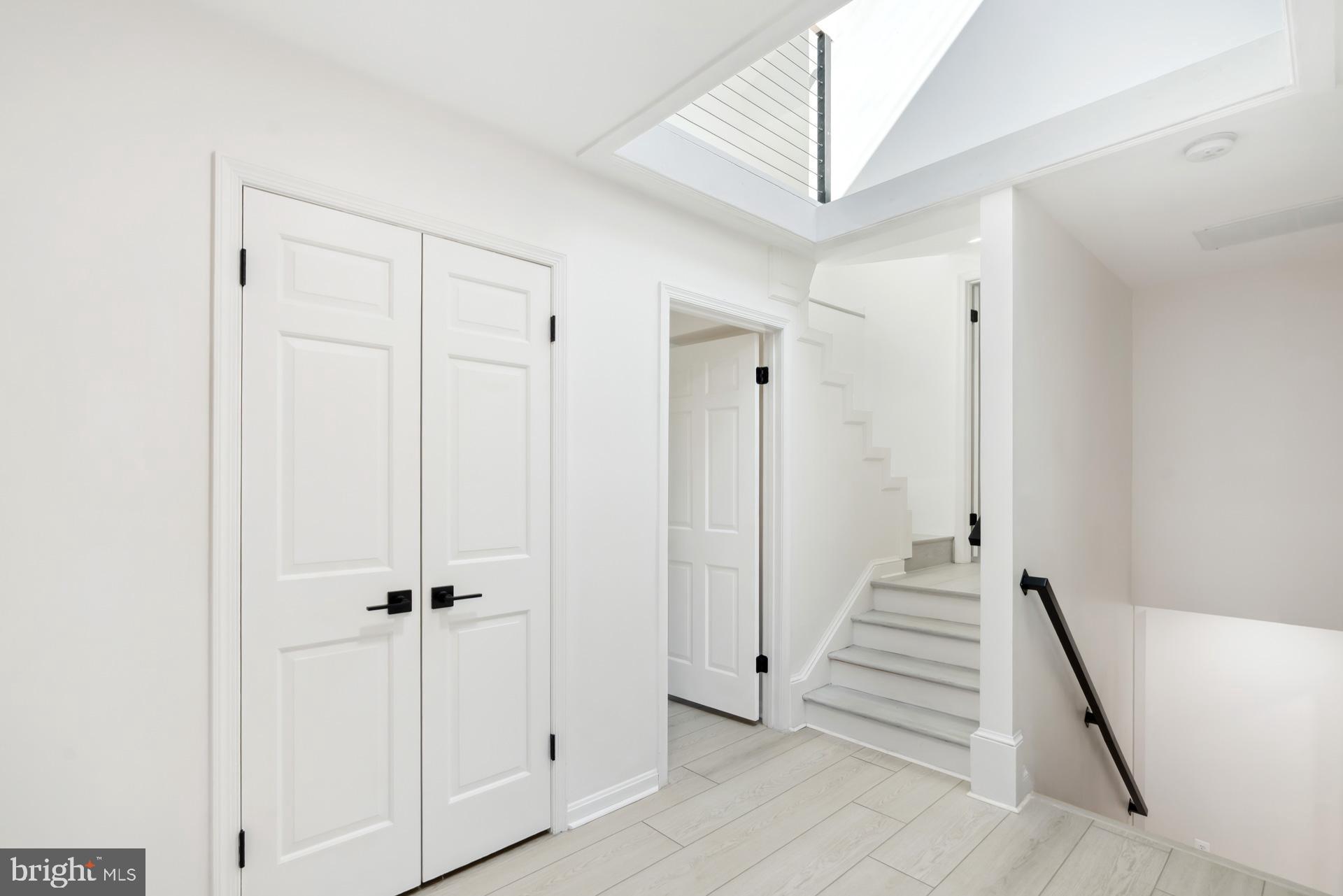 8417 Kingsgate Road Potomac, MD 20854 - Photo 50 of 61 a view of a hallway with a white walls and wooden floor