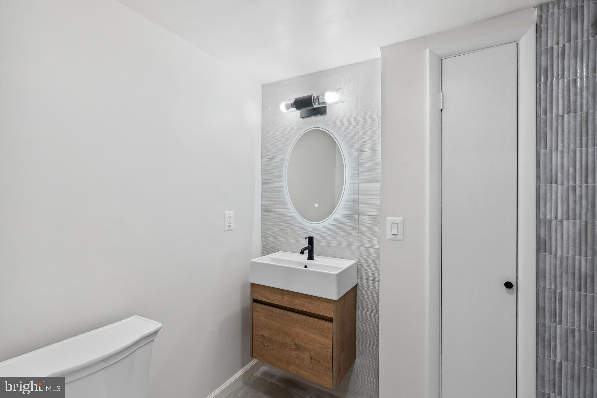 8417 Kingsgate Road Potomac, MD 20854 - Photo 56 of 61 a bathroom with a sink a toilet and a mirror