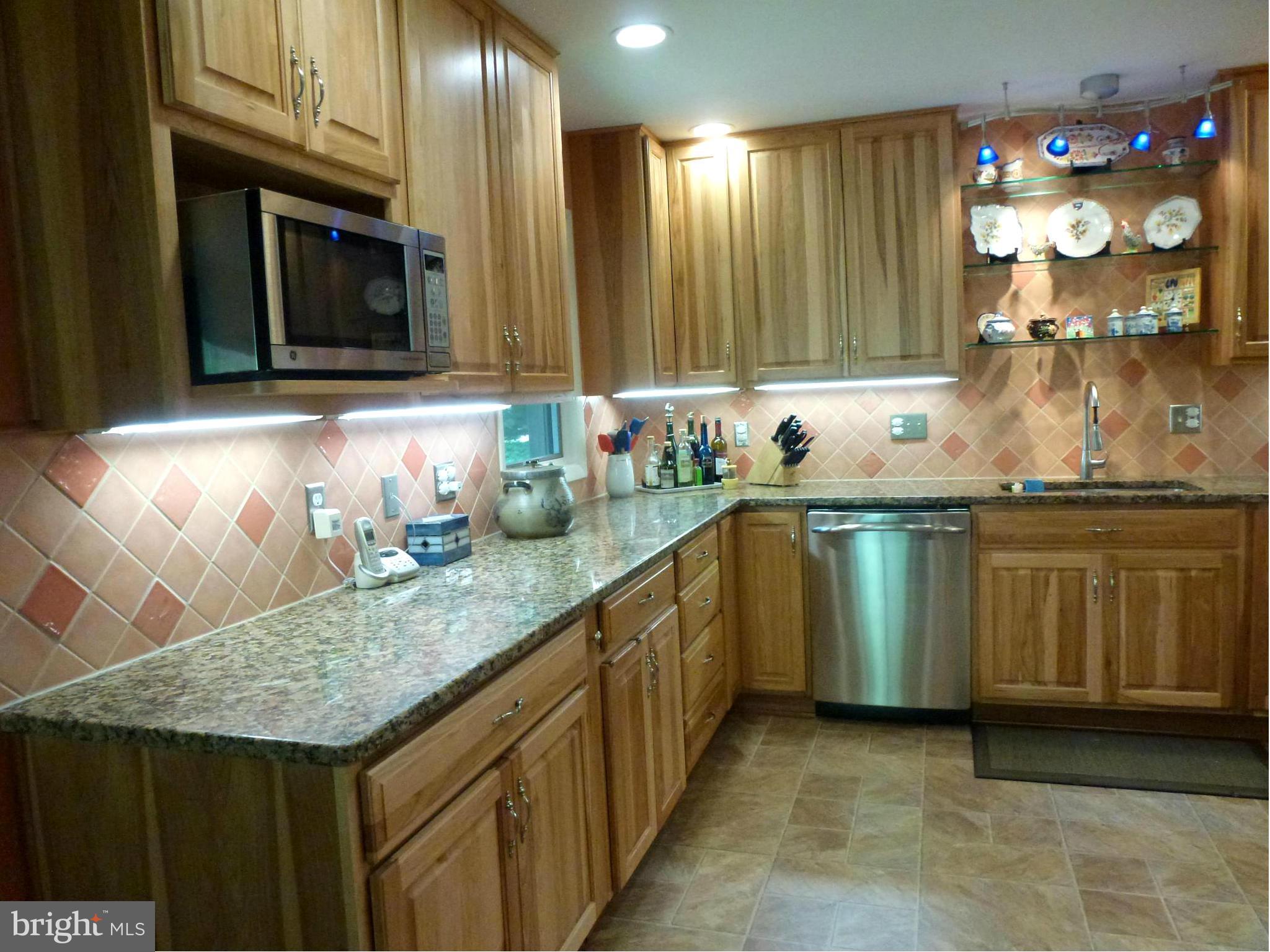 Kitchen features hickory cabinets.