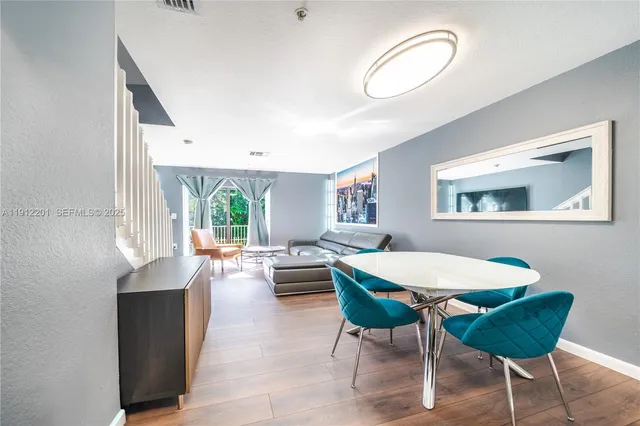a view of a dining room with furniture and a large window