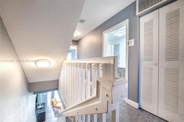 a view of a hallway with entryway wooden floor and front door