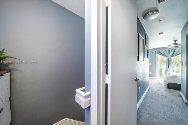 a view of a hallway with wooden floor and a hallway