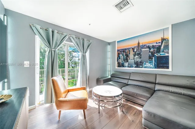 a living room with furniture and a large window