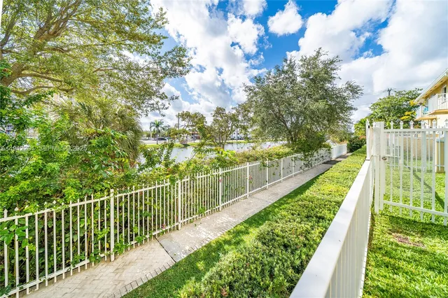 a view of a yard and swimming pool
