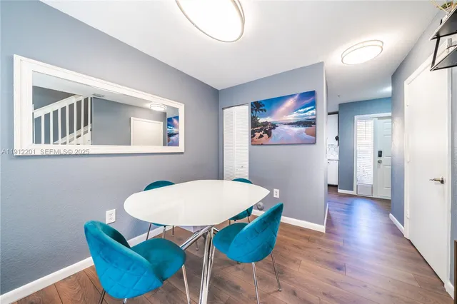 a view of a dining room with furniture wooden floor and a chandelier