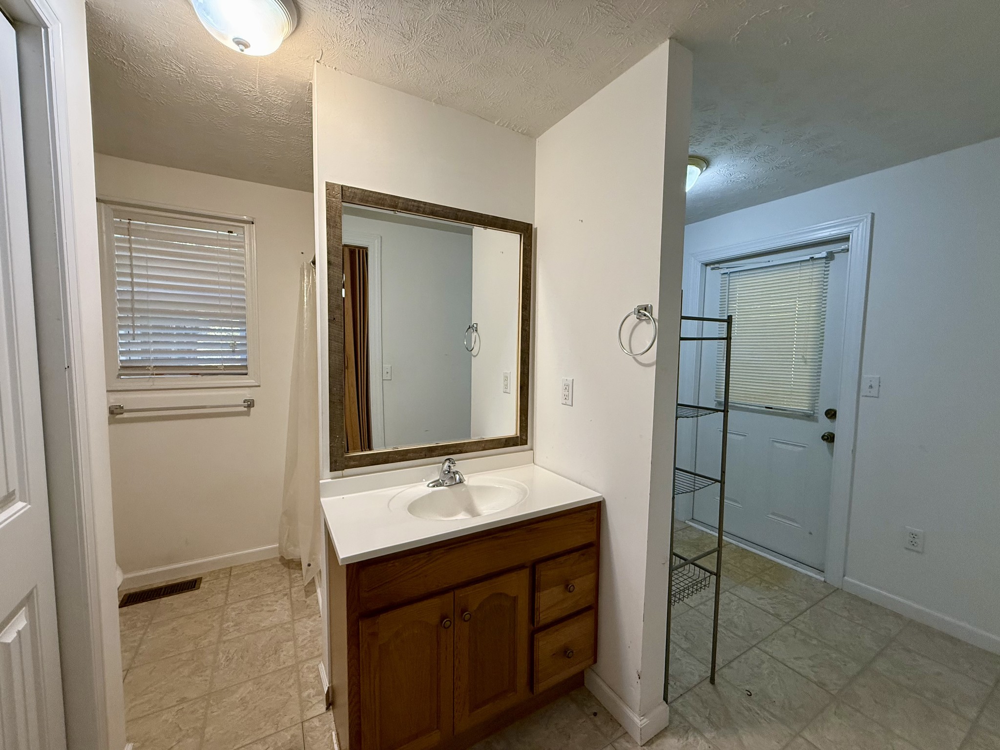135 Haylee Road Waverly, TN 37185 - Photo 18 of 21 a bathroom with a double vanity sink a mirror and a shower