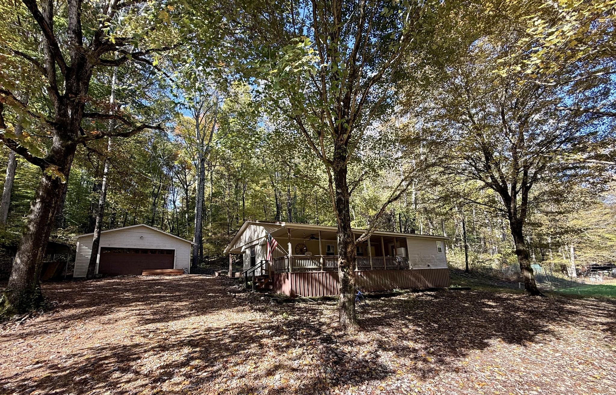 135 Haylee Road Waverly, TN 37185 - Photo 2 of 21 a view of a barn with big plants and large trees
