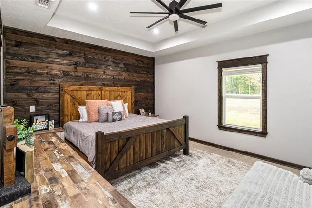 a bedroom with a bed and a window