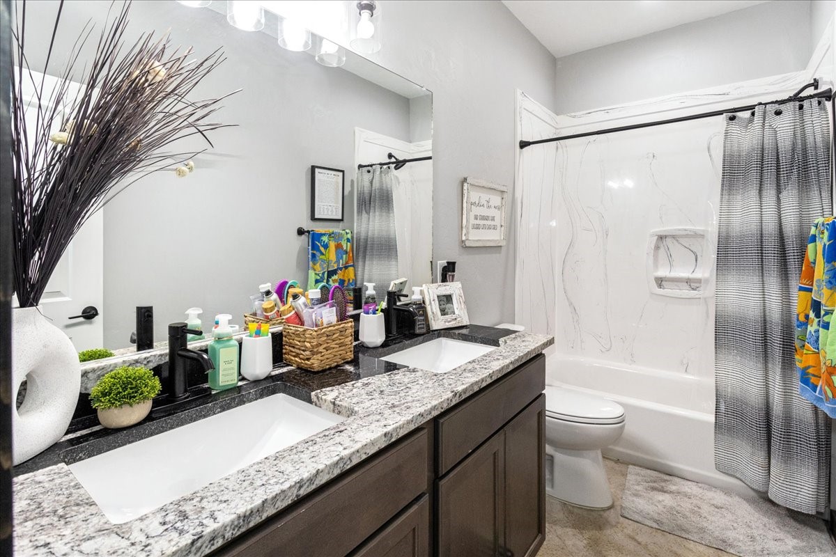 2032 Pahal Road Huntington, TX 75949 - Photo 24 of 45 a bathroom with a granite countertop sink a toilet and shower