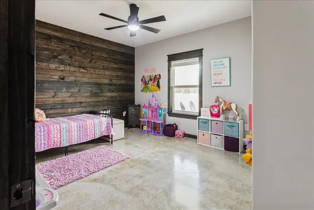 a bedroom with a bed and a couch