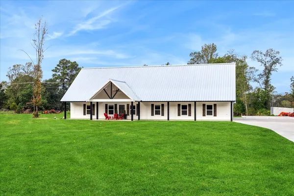 a front view of a house with a garden