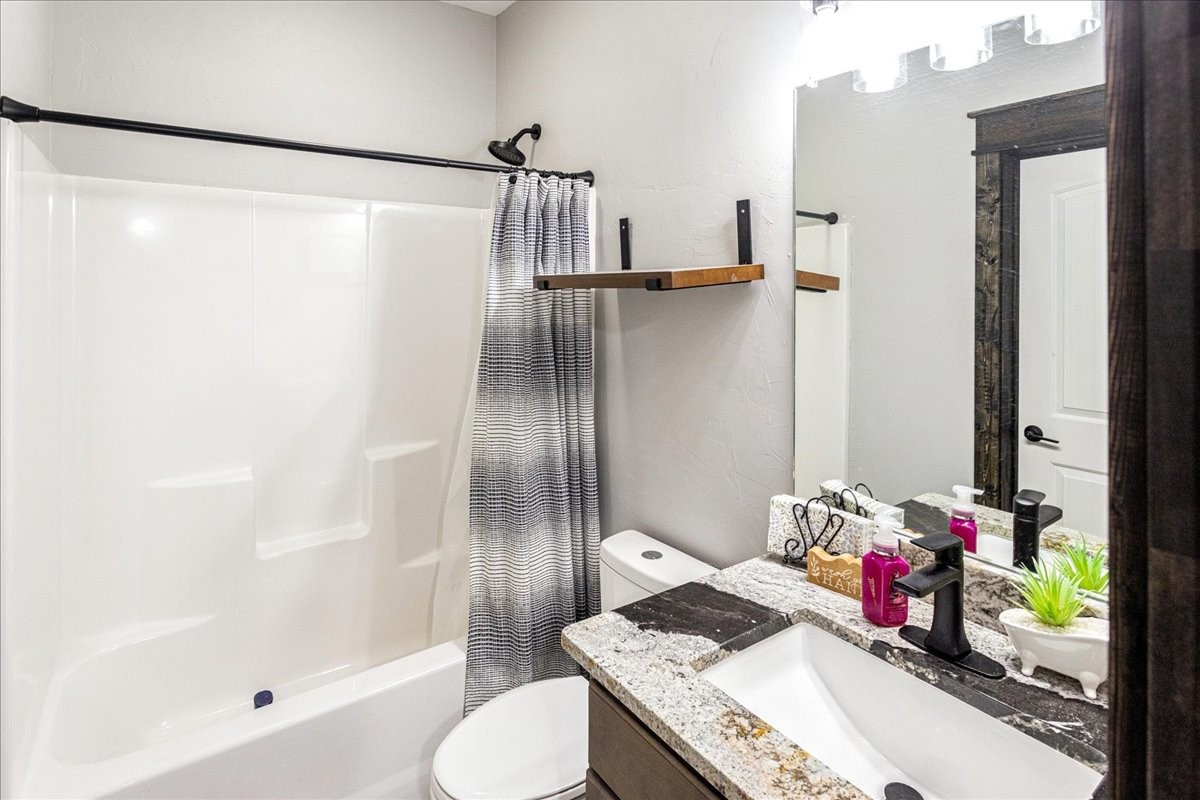 2032 Pahal Road Huntington, TX 75949 - Photo 35 of 45 a bathroom with a granite countertop sink a toilet and shower