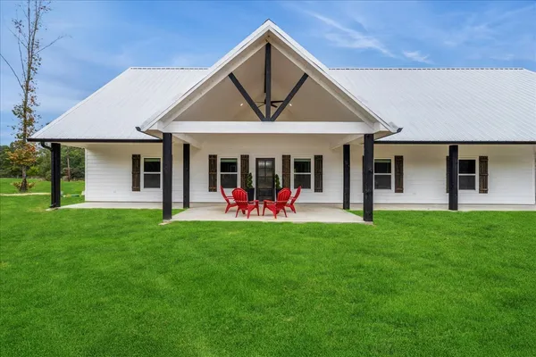 a view of a house with a yard and porch