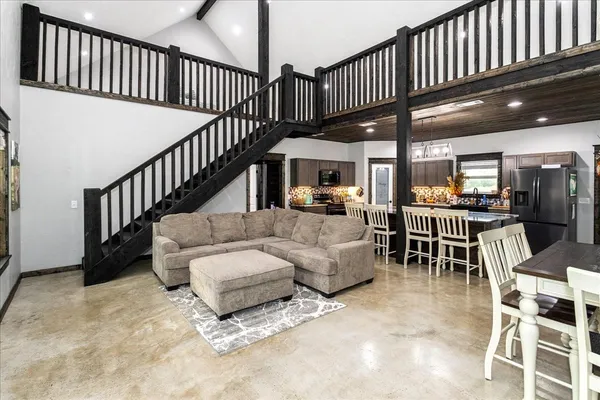 a view of a livingroom with furniture and lots of furniture