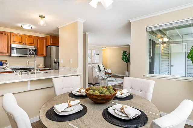 a kitchen with furniture and a dining table