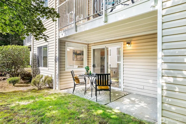 a view of a house with backyard and sitting area