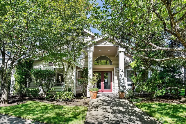 a view of a sign board with large trees