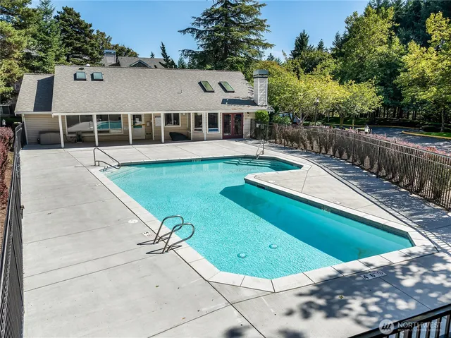 a view of a house with pool and a yard