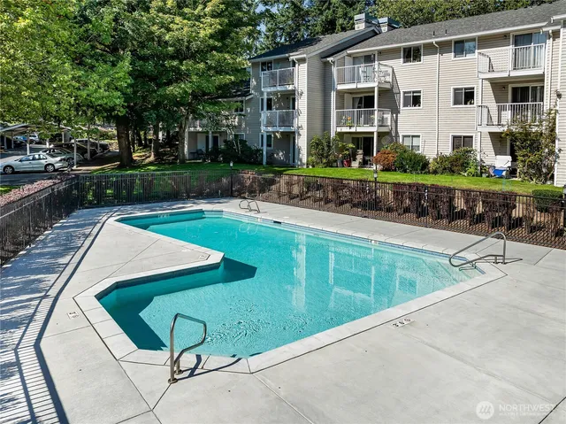 a view of a house with backyard sitting area and swimming pool