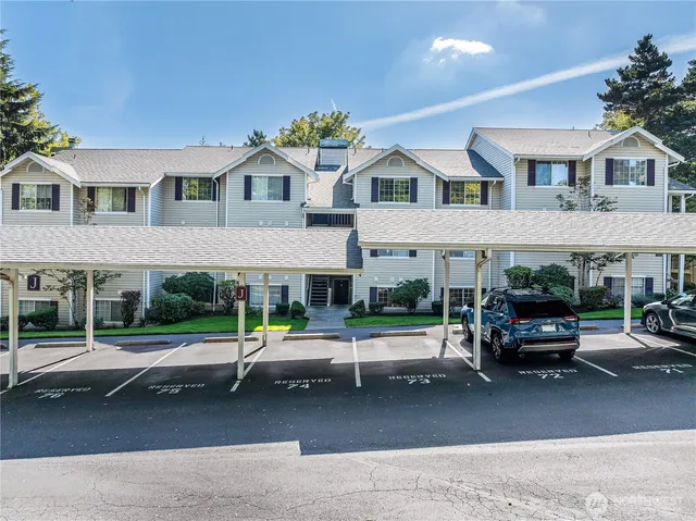 a view of a white house with large windows and table